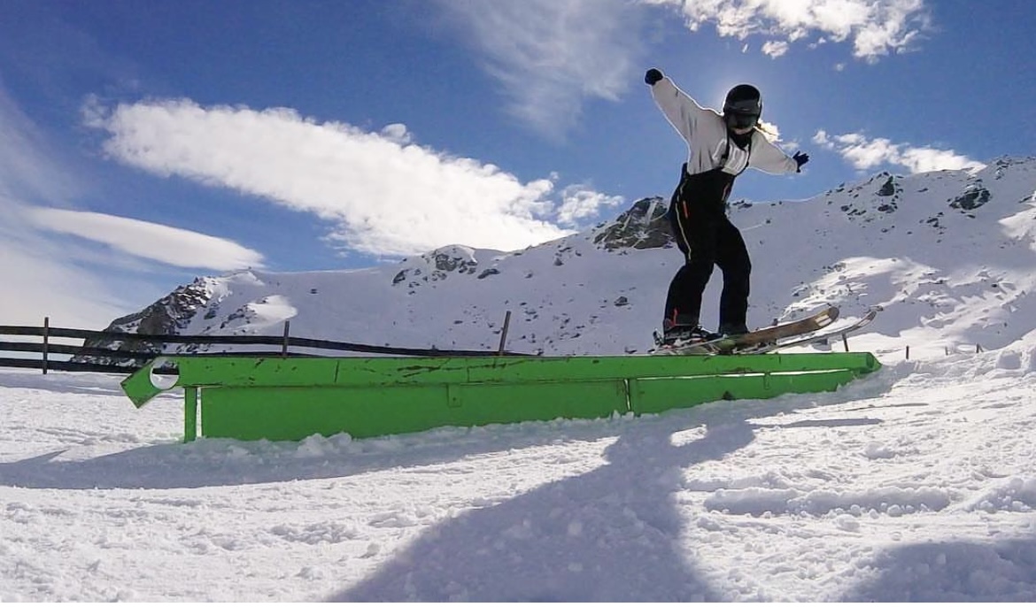 sarah on her skis in the park doing a rail