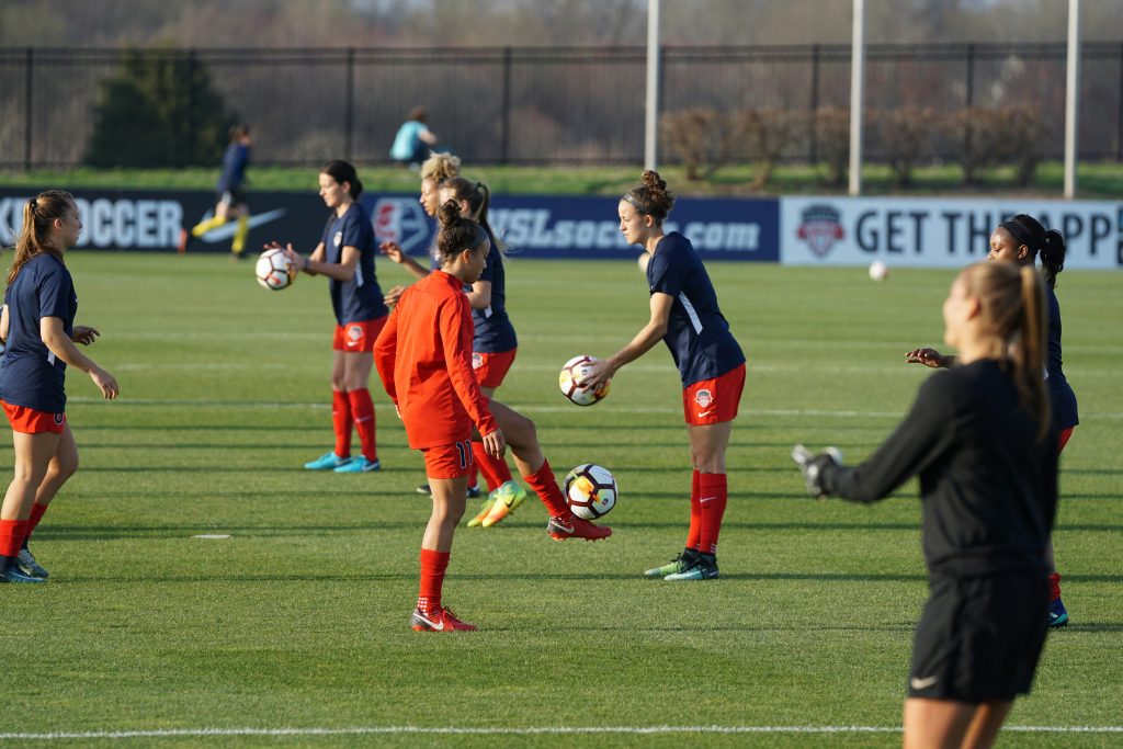 womens soccer team warming up on grass