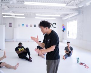 Josh speaking to a class with a white background